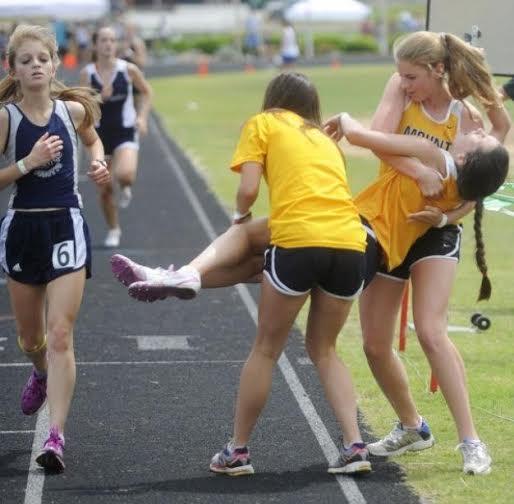 Kayla Montgomery is caught by two teammates at the end of a race during track season. (Courtney Montgomery photo)