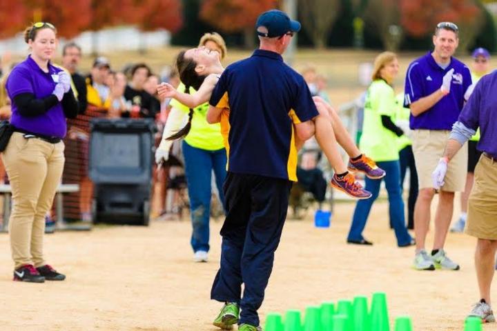 Kayla Montgomery 'caught' at the finish line of the North Carolina state meet. (Dr. Phil Ponder photo)