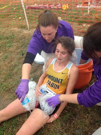 Kayla Montgomery receives treatment at the conclusion of the state meet. (Patrick Cromwell photo)